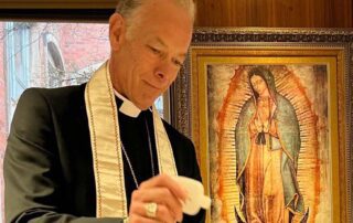 Archbishop Sample blesses the pocket icons
