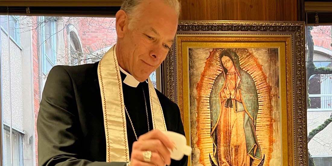 Archbishop Sample blesses the pocket icons